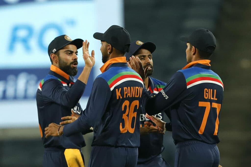 Virat Kohli with teammates Pandya and Gill during an ODI match for India.